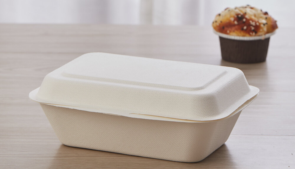 A close-up of a durable bagasse clamshell with a secure locking tab